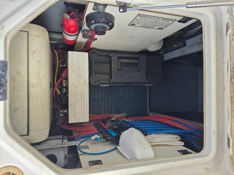Slide: The Image of Engine compartment of a 2002 Silverton 38 Convertible boat with wiring and fire extinguisher. - 19