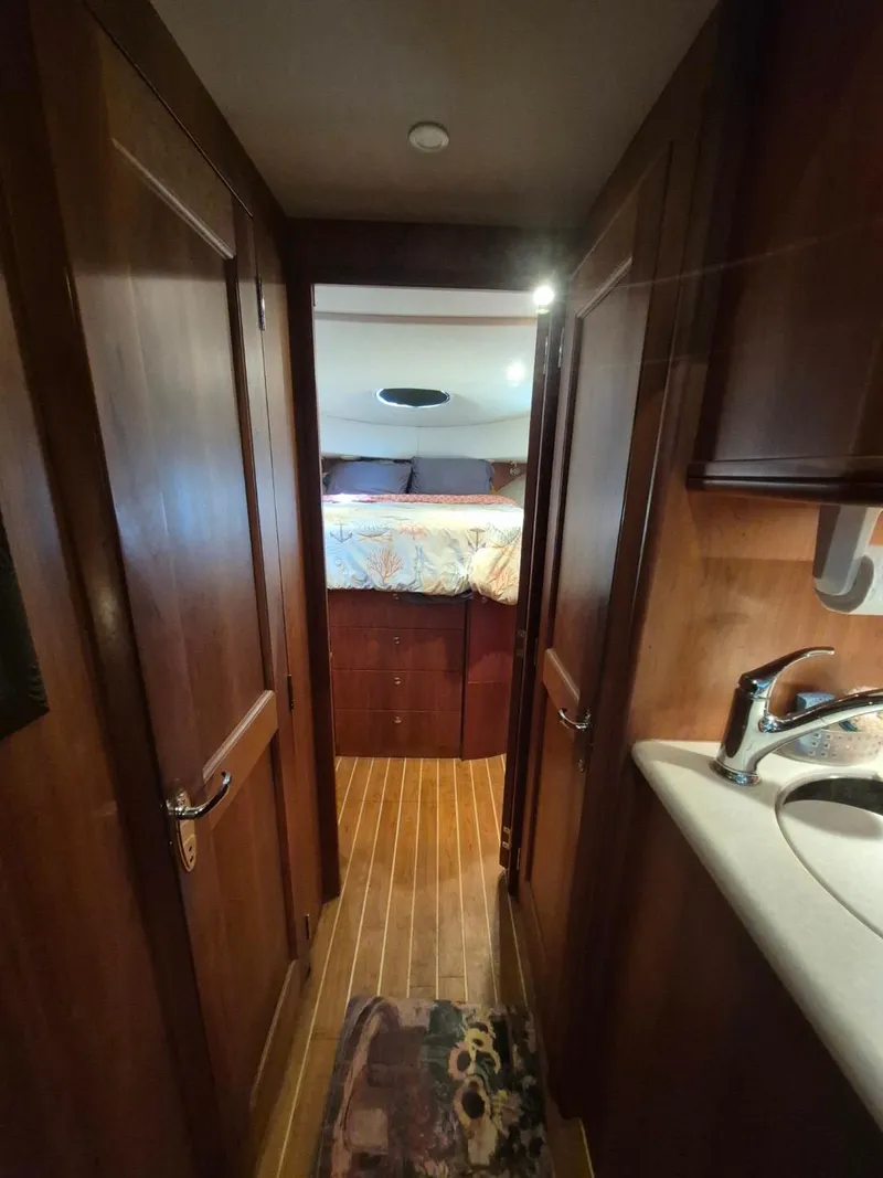 Slide: The Image of Interior of 2002 Silverton 38 Convertible yacht, featuring a cozy cabin and wooden finishes. - 38
