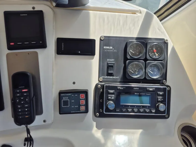 Slide: The Image of Control panel of a 2002 Silverton 38 Convertible boat with gauges and electronics. - 13