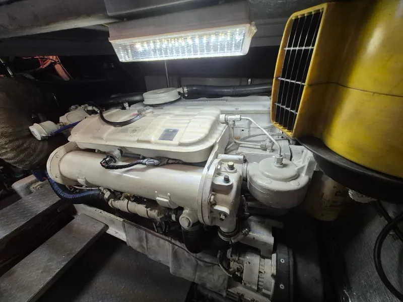 Slide: The Image of Engine room of a 2002 Silverton 38 Convertible boat, featuring a well-maintained engine. - 44