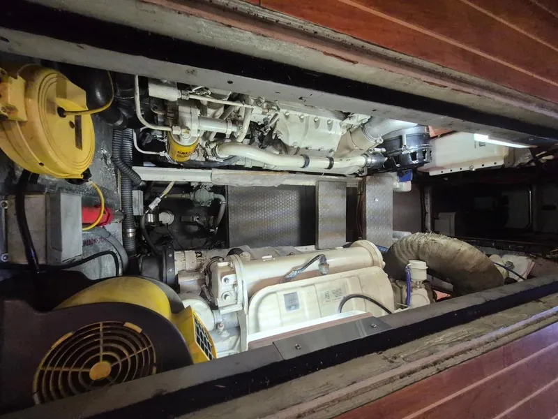 Slide: The Image of Engine room of a 2002 Silverton 38 Convertible boat, showcasing mechanical components. - 43
