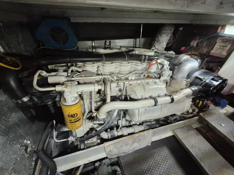 Slide: The Image of Engine room of a 2002 Silverton 38 Convertible boat, featuring a CAT diesel engine. - 41