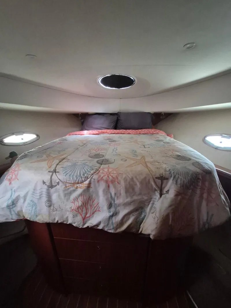 Slide: The Image of Cozy bedroom in 2002 Silverton 38 Convertible yacht with nautical-themed bedding. - 33