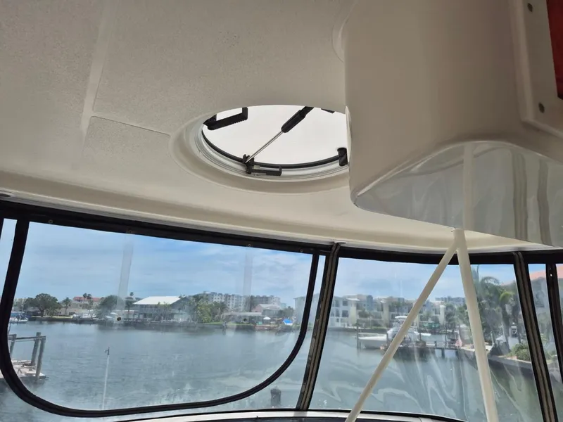 Slide: The Image of Interior view from a 2002 Silverton 38 Convertible yacht, overlooking a marina. - 18
