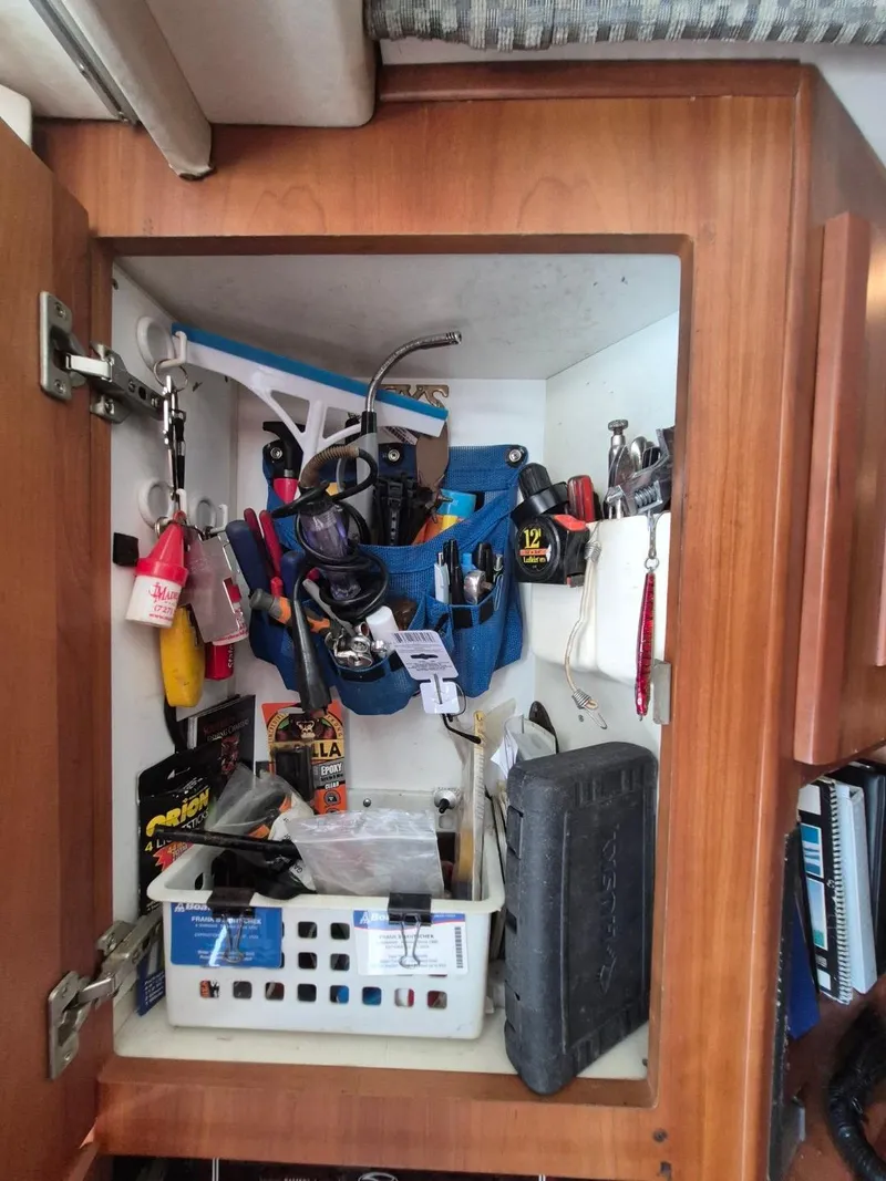 Slide: The Image of Cabinet with tools and supplies on a 2002 Silverton 38 Convertible boat. - 26