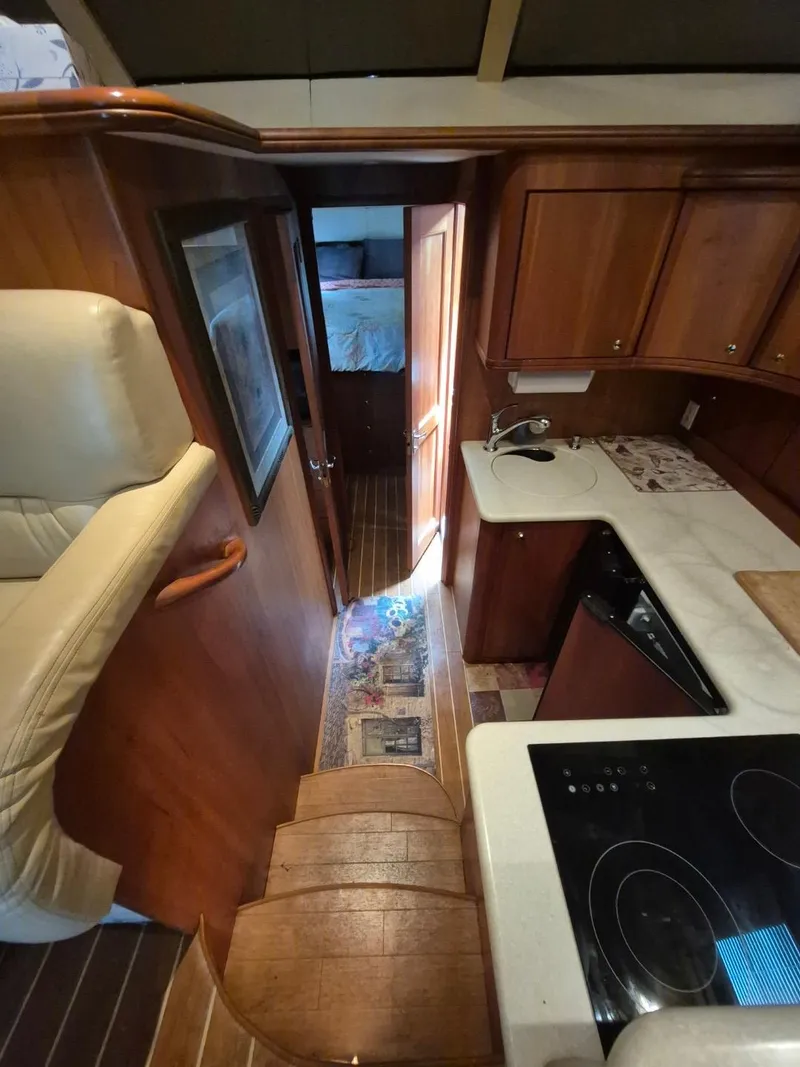 Slide: The Image of Interior of 2002 Silverton 38 Convertible yacht with wooden cabinetry and compact kitchen. - 29