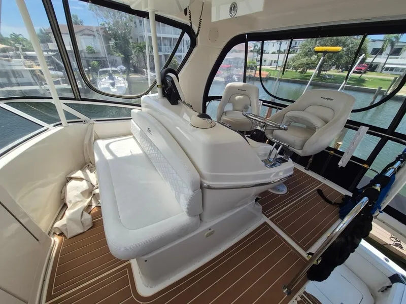 Slide: The Image of Interior of a 2002 Silverton 38 Convertible yacht with helm and seating area. - 9
