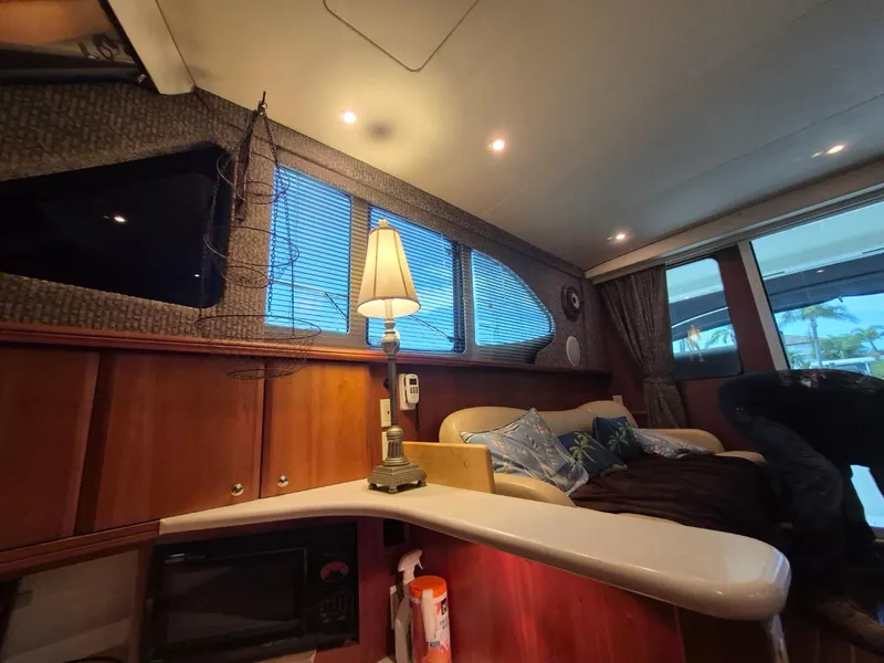 Slide: The Image of Interior of 2002 Silverton 38 Convertible yacht with cozy seating and elegant decor. - 40