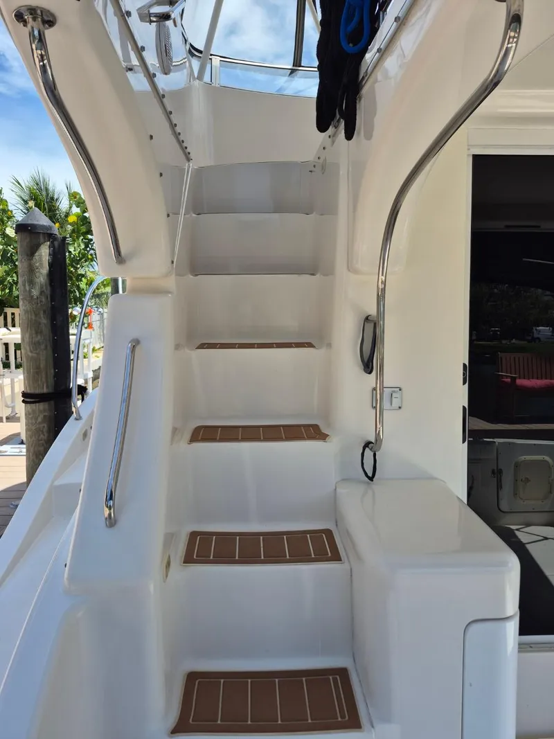 Slide: The Image of Staircase on a 2002 Silverton 38 Convertible yacht, featuring sleek design and stainless steel railings. - 8