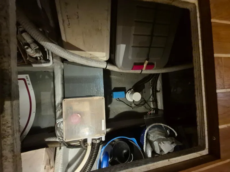 Slide: The Image of Engine compartment of a 2002 Silverton 38 Convertible boat, showing various equipment and wiring. - 35