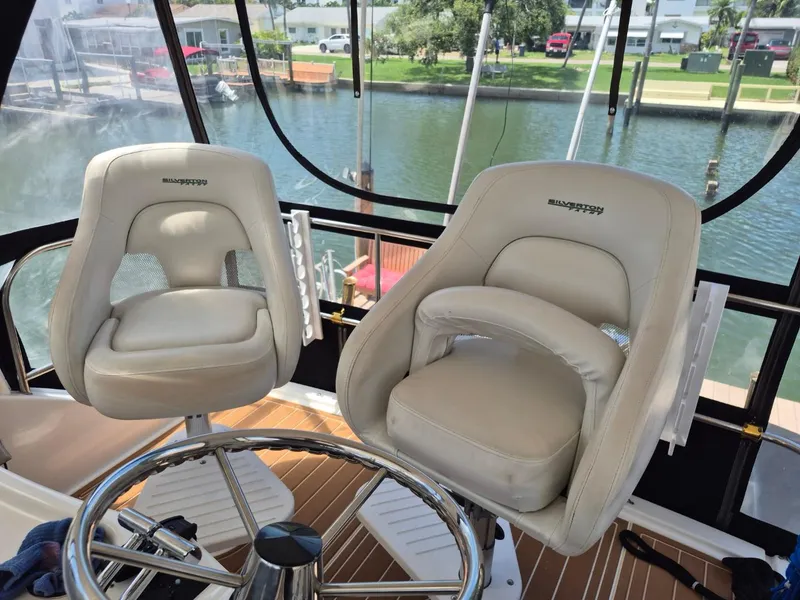 Slide: The Image of Captain's chairs on 2002 Silverton 38 Convertible yacht, overlooking marina. - 15