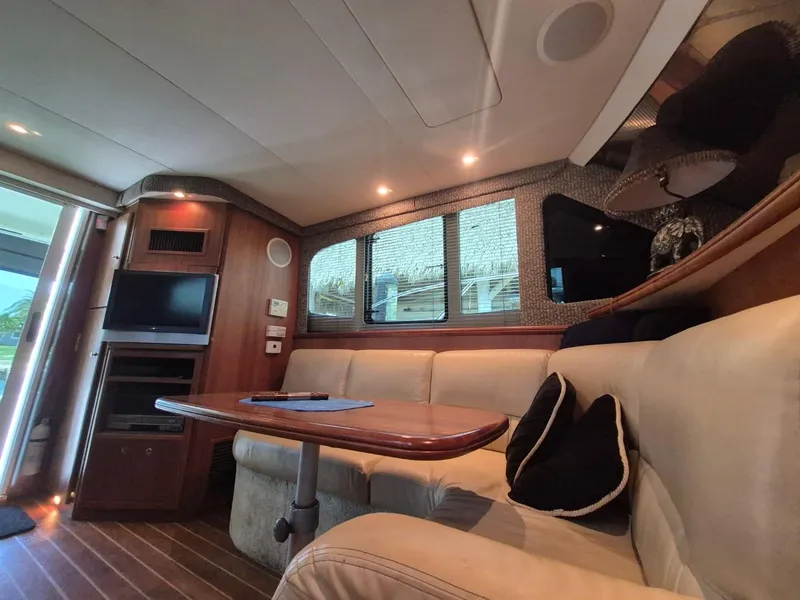 Slide: The Image of Interior of 2002 Silverton 38 Convertible yacht with cozy seating and entertainment area. - 39
