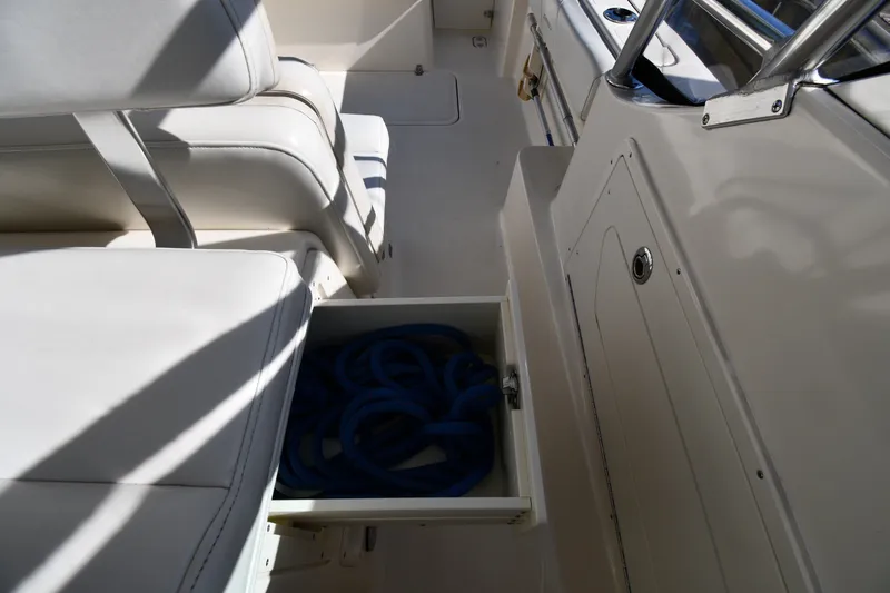 Slide: The Image of Interior of 2004 Pursuit 2670 Denali LS boat with open storage compartment. - 23