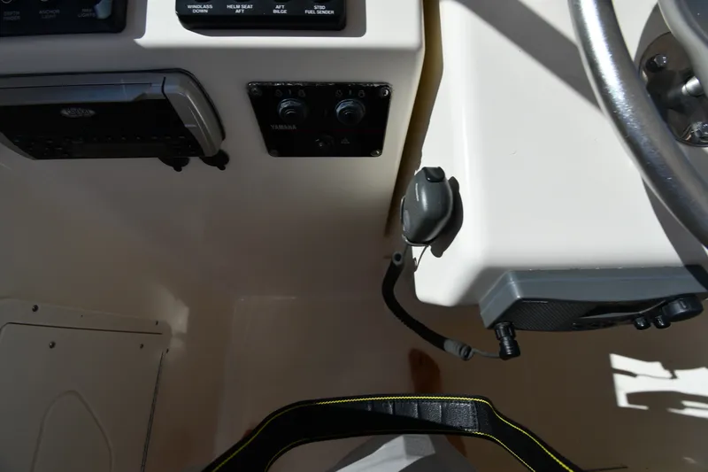Slide: The Image of 2004 Pursuit 2670 Denali LS boat dashboard with steering wheel and controls. - 12