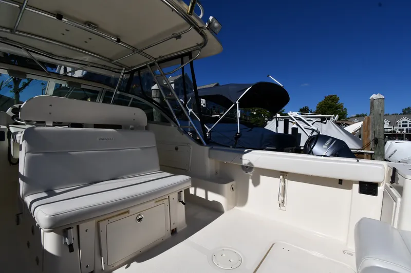 Slide: The Image of 2004 Pursuit 2670 Denali LS boat interior with seating and Yamaha outboard motor. - 16