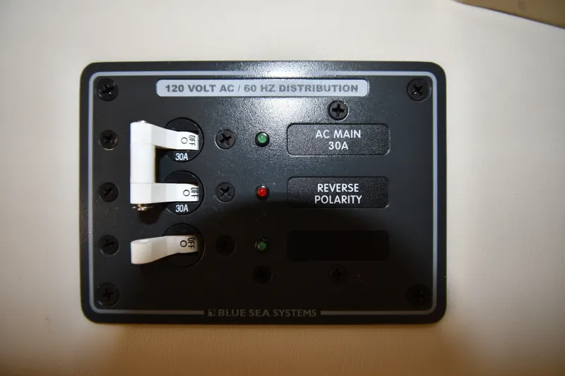 Slide: The Image of Electrical panel with 120V AC distribution, featuring 30A switches and reverse polarity indicator. - 34