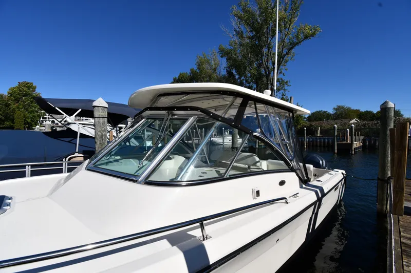 Slide: The Image of 2004 Pursuit 2670 Denali LS boat docked on a sunny day. - 2
