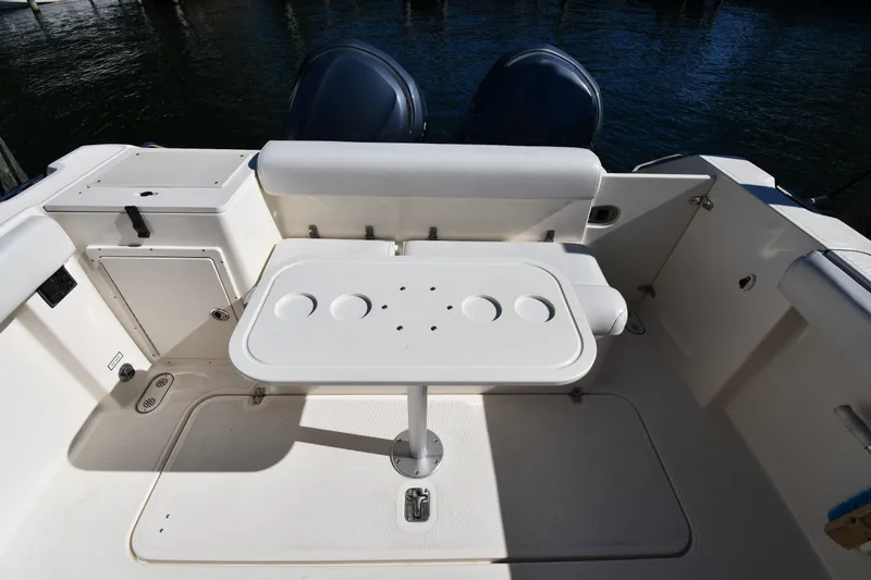 Slide: The Image of 2004 Pursuit 2670 Denali LS boat interior with table and seating area. - 26