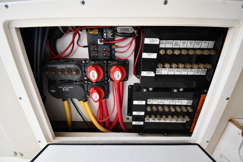 Slide: The Image of Electrical panel of a 2004 Pursuit 2670 Denali LS boat with labeled circuits and switches. - 36