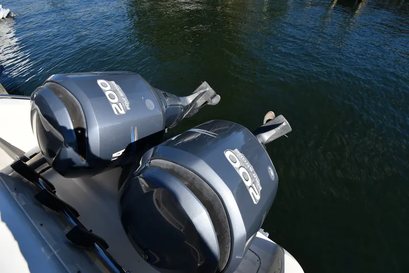 Slide: The Image of Twin 200 horsepower outboard motors on a 2004 Pursuit 2670 Denali LS boat. - 18