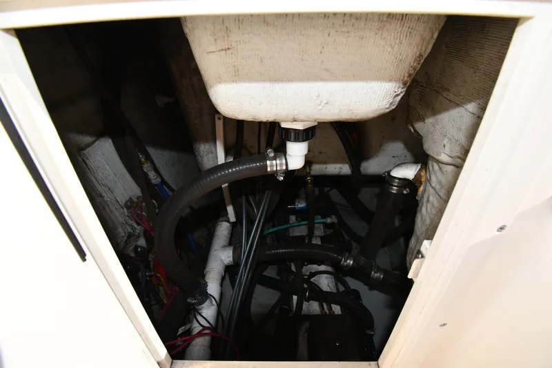 Slide: The Image of Engine compartment of a 2004 Pursuit 2670 Denali LS boat, showing hoses and wiring. - 21