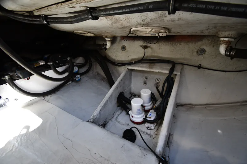 Slide: The Image of Engine compartment of a 2004 Pursuit 2670 Denali LS boat, showing hoses and filters. - 39