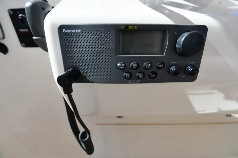Slide: The Image of Raymarine marine radio on 2004 Pursuit 2670 Denali LS boat dashboard. - 14