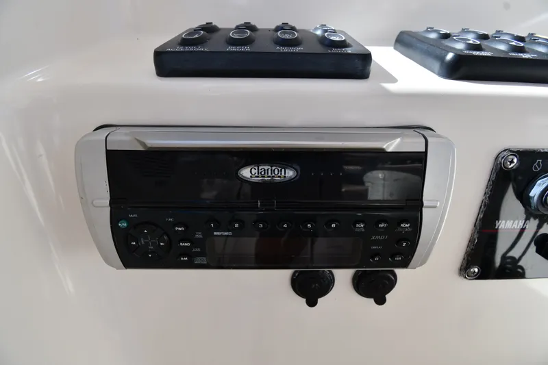 Slide: The Image of Clarion stereo system on 2004 Pursuit 2670 Denali LS boat dashboard. - 13