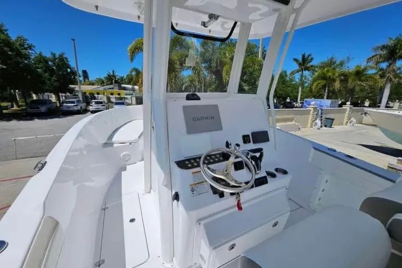 Slide: The Image of 2022 Century 2900 Center Console boat with Garmin navigation, parked outdoors. - 5
