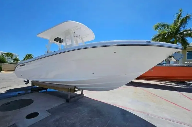 Slide: The Image of 2022 Century 2900 Center Console boat on display, clear sky background. - 2