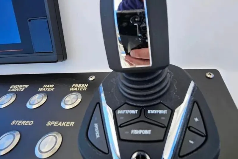 Slide: The Image of Control panel of a 2022 Century 2900 Center Console boat with joystick and buttons. - 8