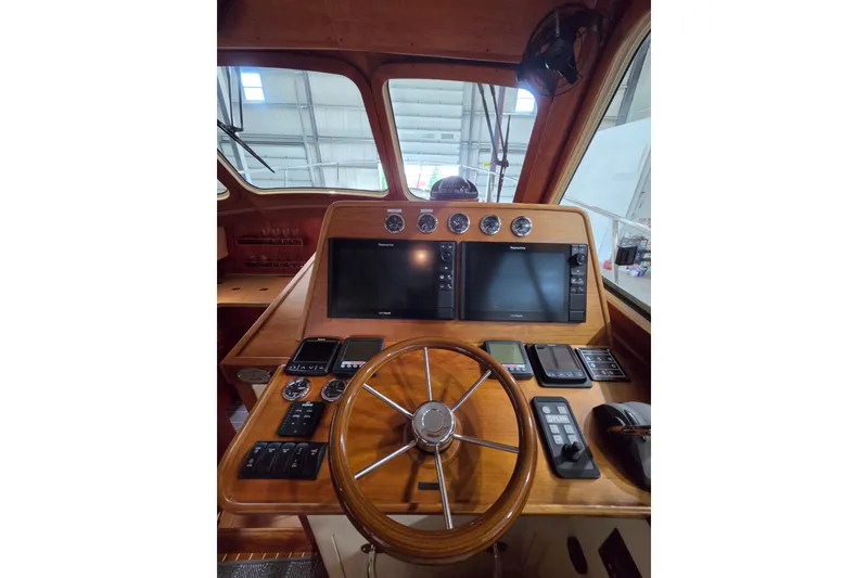 Slide: The Image of Helm of 2009 Hinckley Talaria 44 yacht with wooden steering wheel and navigation instruments. - 5