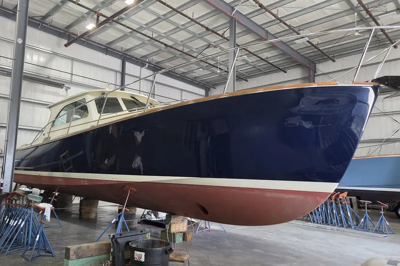 Slide: The Image of 2009 Hinckley Talaria 44 yacht in a boatyard, showcasing sleek design and craftsmanship. - 4