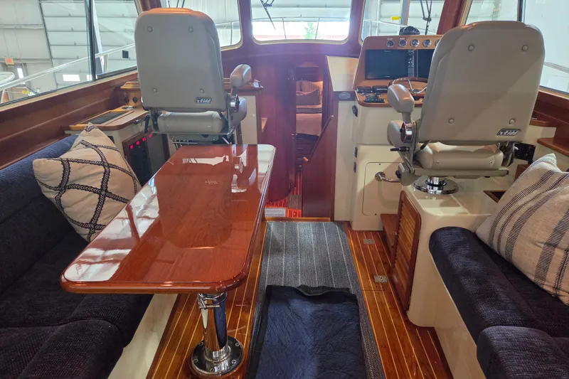 Slide: The Image of Luxurious interior of a 2009 Hinckley Talaria 44 yacht with plush seating and polished wood finishes. - 6