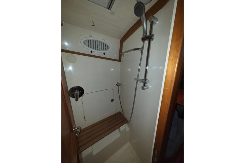 Slide: The Image of Shower area in 2009 Hinckley Talaria 44 yacht with wooden seat and chrome fixtures. - 13