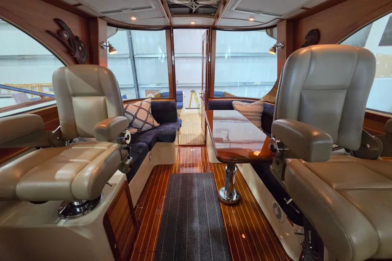Slide: The Image of Luxurious interior of 2009 Hinckley Talaria 44 yacht with plush seating and wooden finishes. - 7