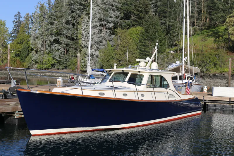 The Image of 2009 Hinckley Talaria 44 yacht docked in a scenic marina setting. - 0