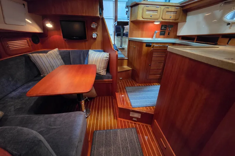 Slide: The Image of Interior of 2009 Hinckley Talaria 44 yacht with wood finish and cozy seating area. - 15
