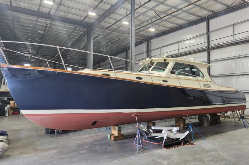 Slide: The Image of 2009 Hinckley Talaria 44 yacht in a warehouse, showcasing sleek design and craftsmanship. - 3