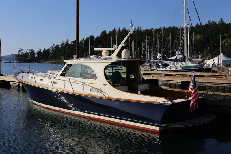 Slide: The Image of 2009 Hinckley Talaria 44 yacht docked at marina with American flag. - 1