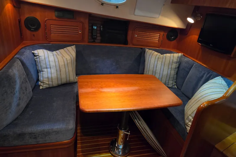 Slide: The Image of Interior of 2009 Hinckley Talaria 44 yacht with cozy seating and wooden table. - 10
