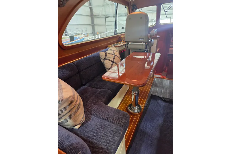 Slide: The Image of Interior of 2009 Hinckley Talaria 44 yacht with plush seating and polished wood table. - 9