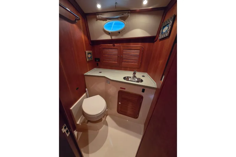 Slide: The Image of Luxurious 2009 Hinckley Talaria 44 yacht bathroom with wooden cabinetry and modern fixtures. - 14