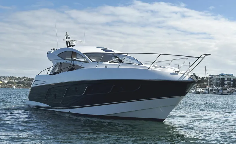 Slide: The Image of 2015 Sunseeker Predator 57 yacht on water, showcasing sleek design and luxury features. - 4