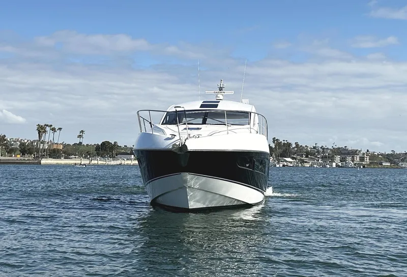 Slide: The Image of 2015 Sunseeker Predator 57 yacht cruising on open water under a clear sky. - 3