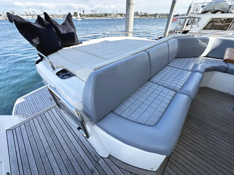 Slide: The Image of Luxurious seating area on a 2015 Sunseeker Predator 57 yacht, overlooking serene waters. - 11