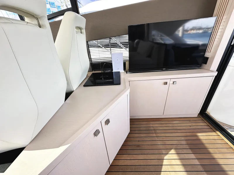 Slide: The Image of Interior of 2015 Sunseeker Predator 57 yacht with modern seating and entertainment area. - 16