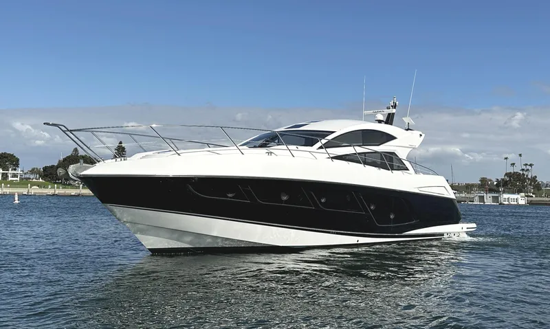 Slide: The Image of 2015 Sunseeker Predator 57 yacht cruising on open water. - 2