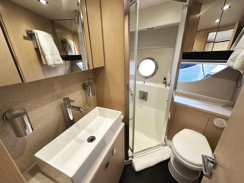 Slide: The Image of Luxurious bathroom in 2015 Sunseeker Predator 57 yacht with modern fixtures and porthole window. - 34