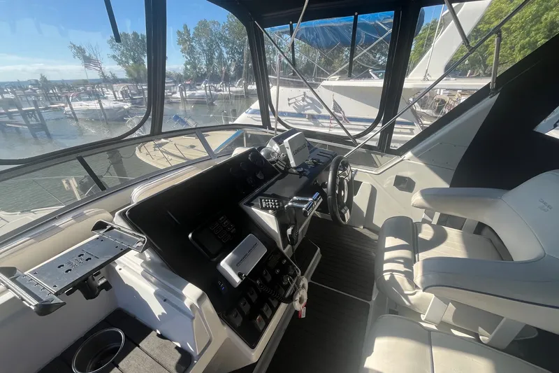 Slide: The Image of Interior helm of 1992 Carver 33 Aft Cabin Motor Yacht with marina view. - 13
